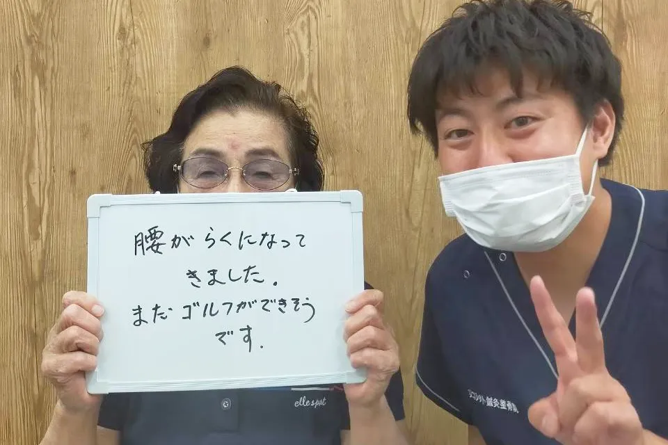 症状が改善した患者と並ぶ整体師